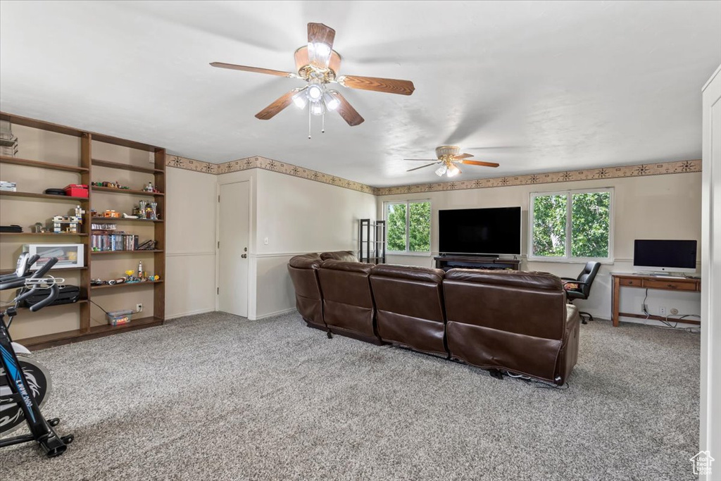 Living area featuring an office area, carpet flooring, and a ceiling fan