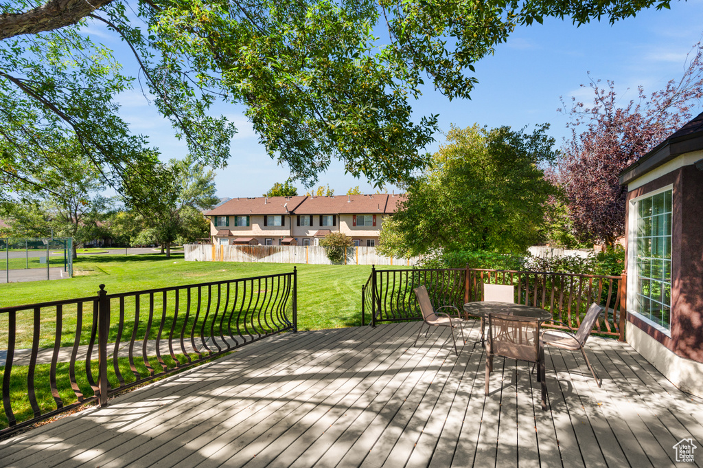 Wooden deck with a yard and outdoor dining space