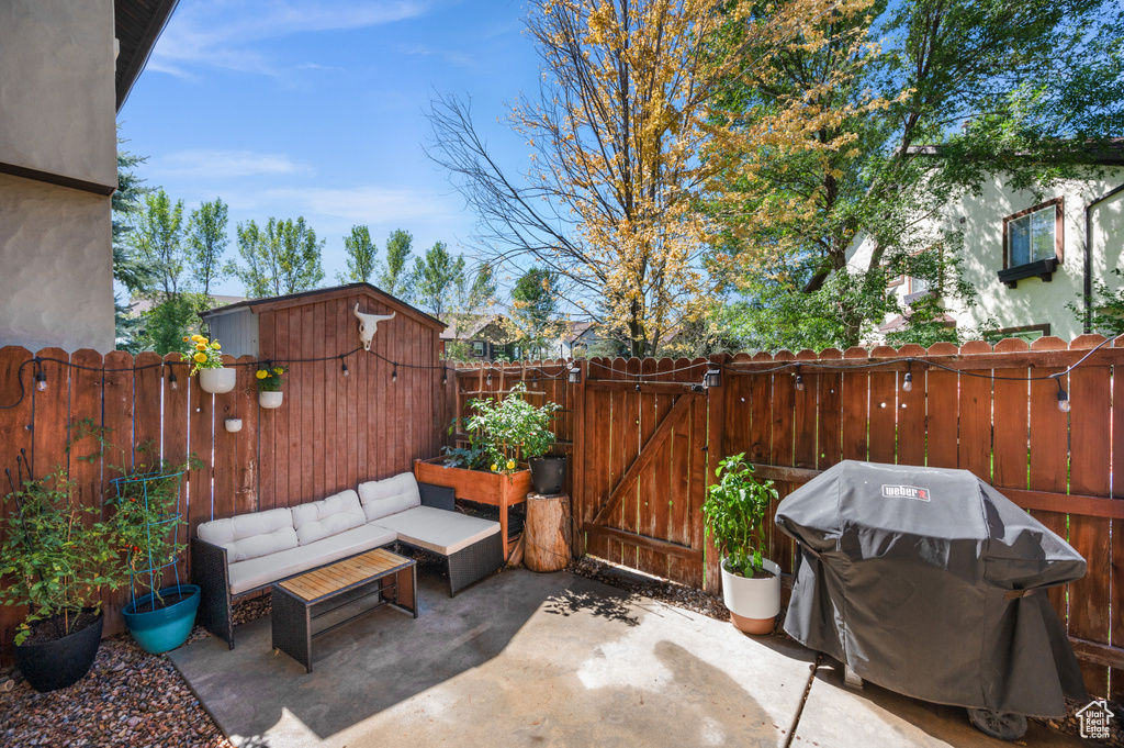 Fenced backyard featuring a patio, area for grilling, and a gate