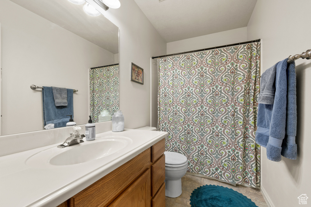 Full bathroom featuring vanity, a shower with curtain, and tile patterned flooring