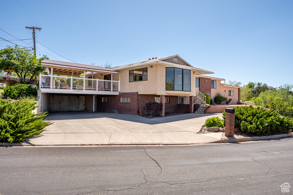View of front facade featuring concrete driveway and brick siding