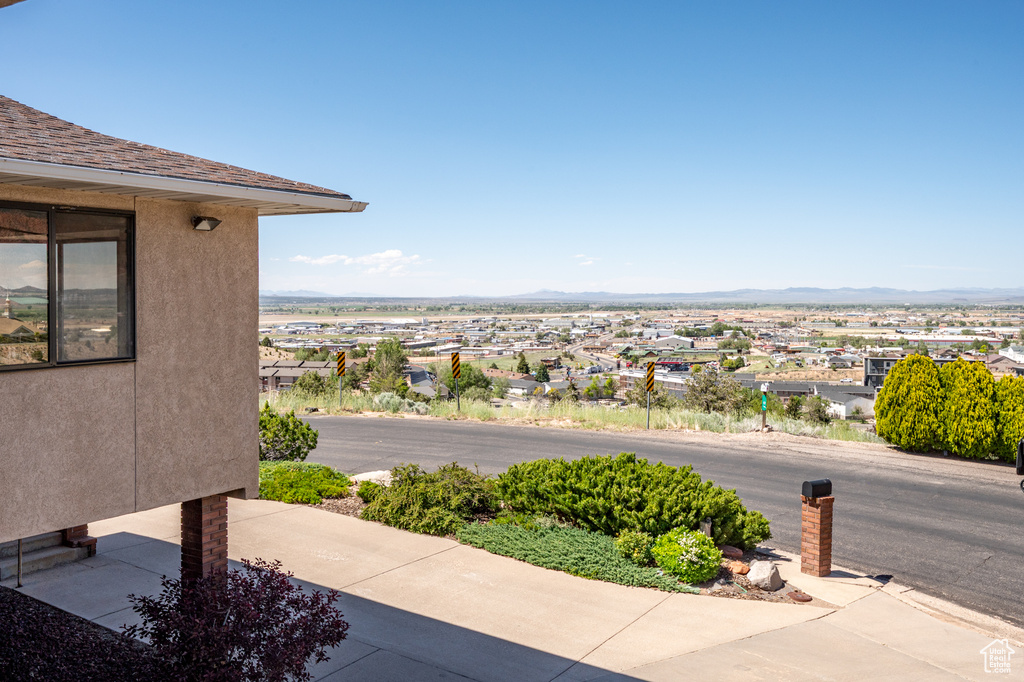 Water view featuring a mountainous background and nearby suburban area