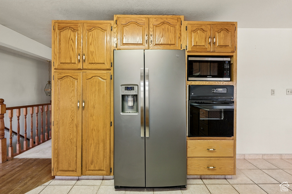Kitchen featuring stainless steel appliances and light tile patterned floors