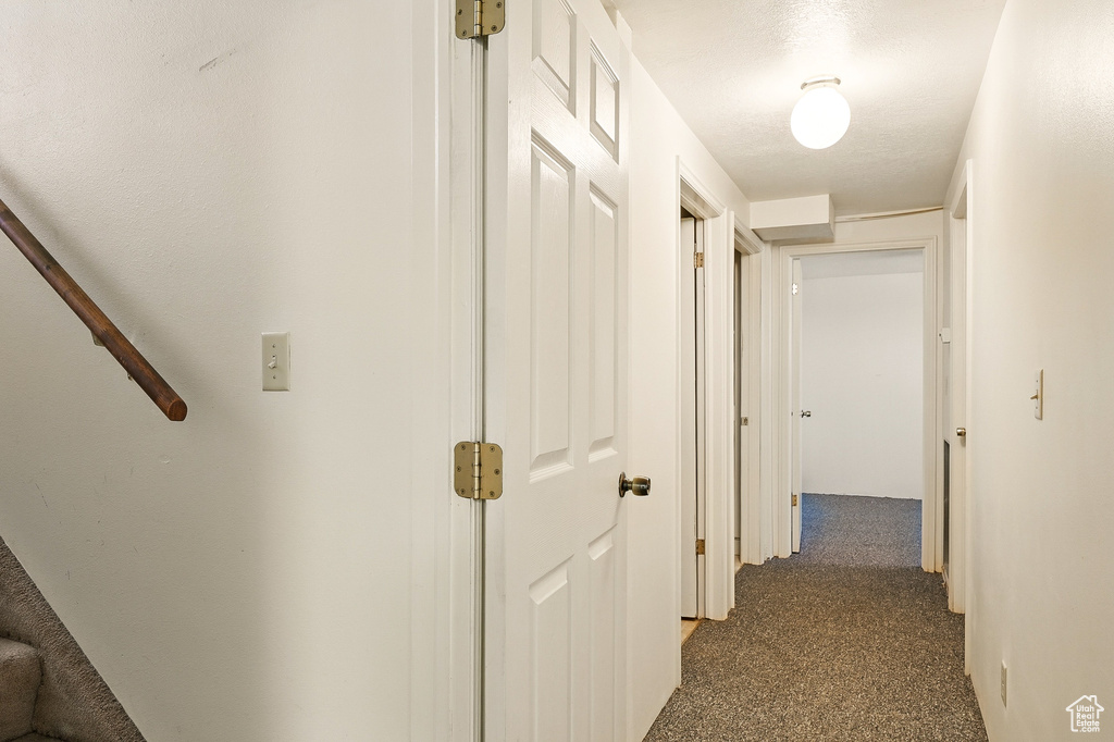 Hall featuring dark carpet