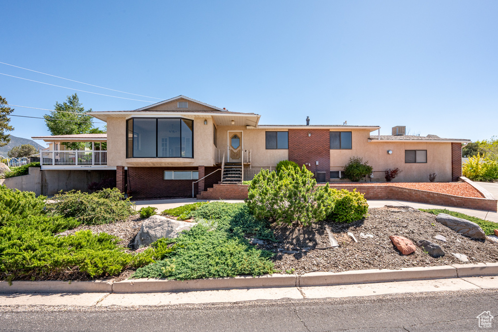 View of front of house with stucco siding and brick siding