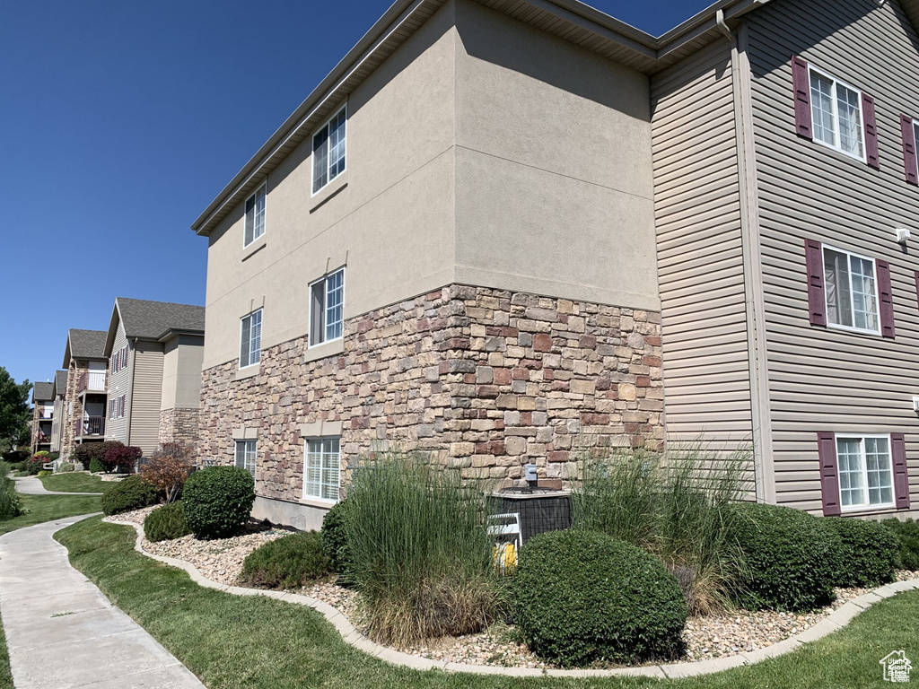 View of home's exterior featuring stone siding and stucco siding