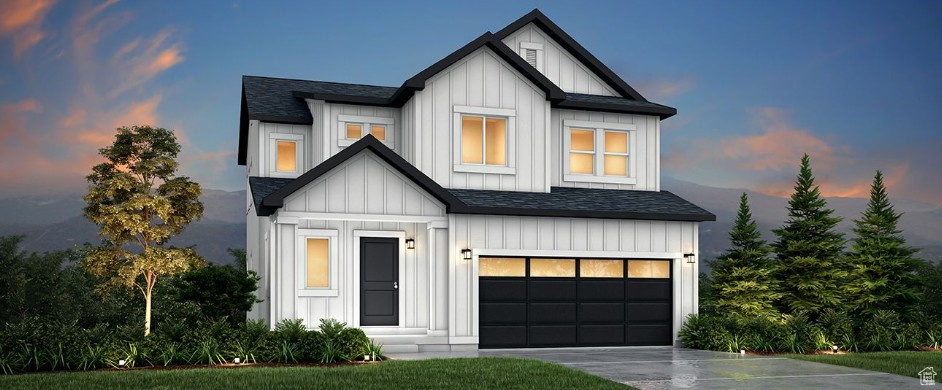 Modern inspired farmhouse with board and batten siding, driveway, and an attached garage