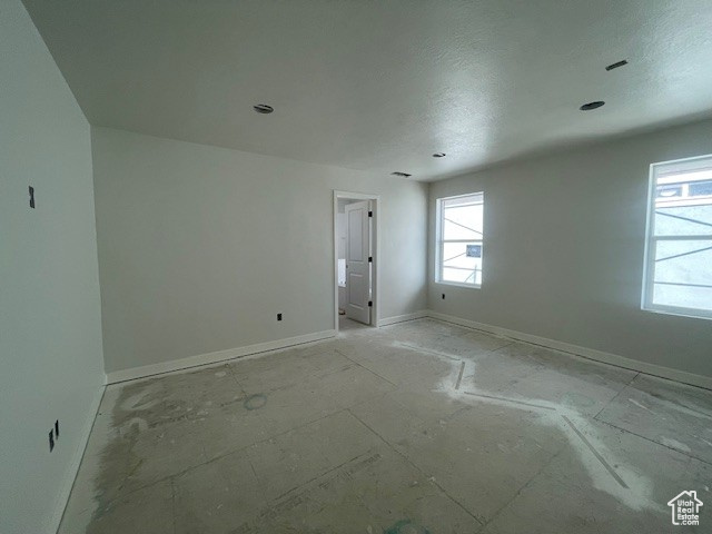 Empty room featuring baseboards