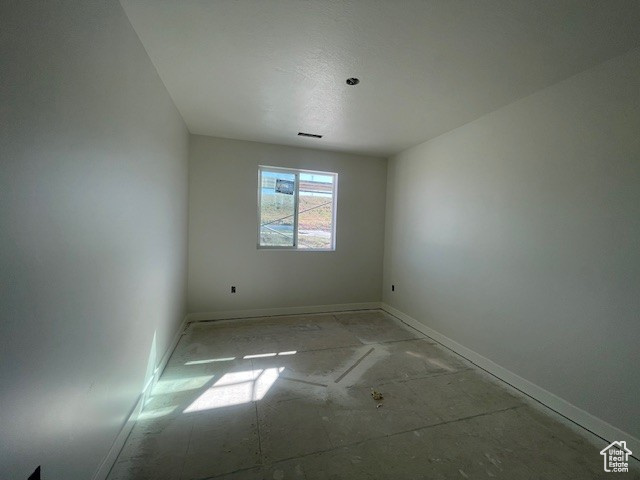 Spare room featuring baseboards