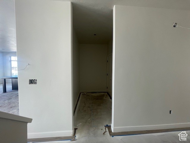 Hallway featuring baseboards