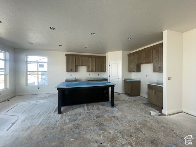 Kitchen featuring dark brown cabinetry and a center island