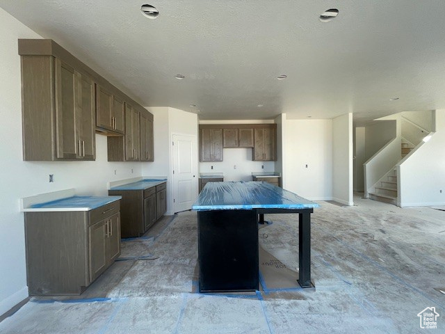Kitchen with a kitchen island and unfinished concrete floors