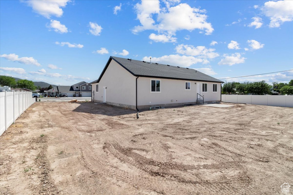 Back of house featuring a fenced backyard