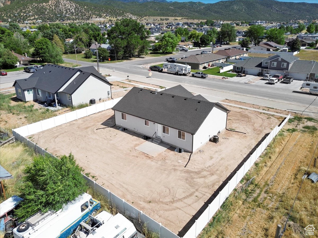 Aerial view of residential area featuring a mountainous background