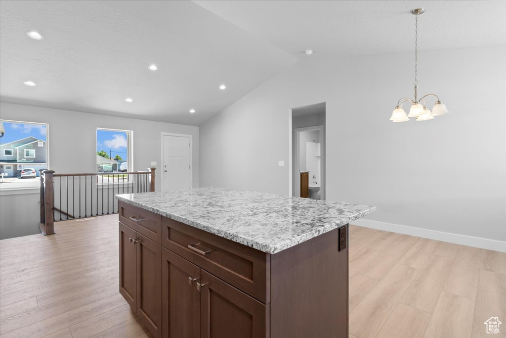 Kitchen featuring light wood-style floors, a chandelier, recessed lighting, hanging light fixtures, and a center island