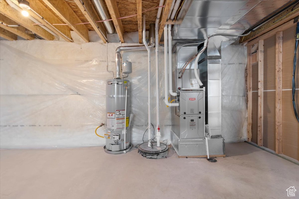 Utility room featuring gas water heater and heating unit