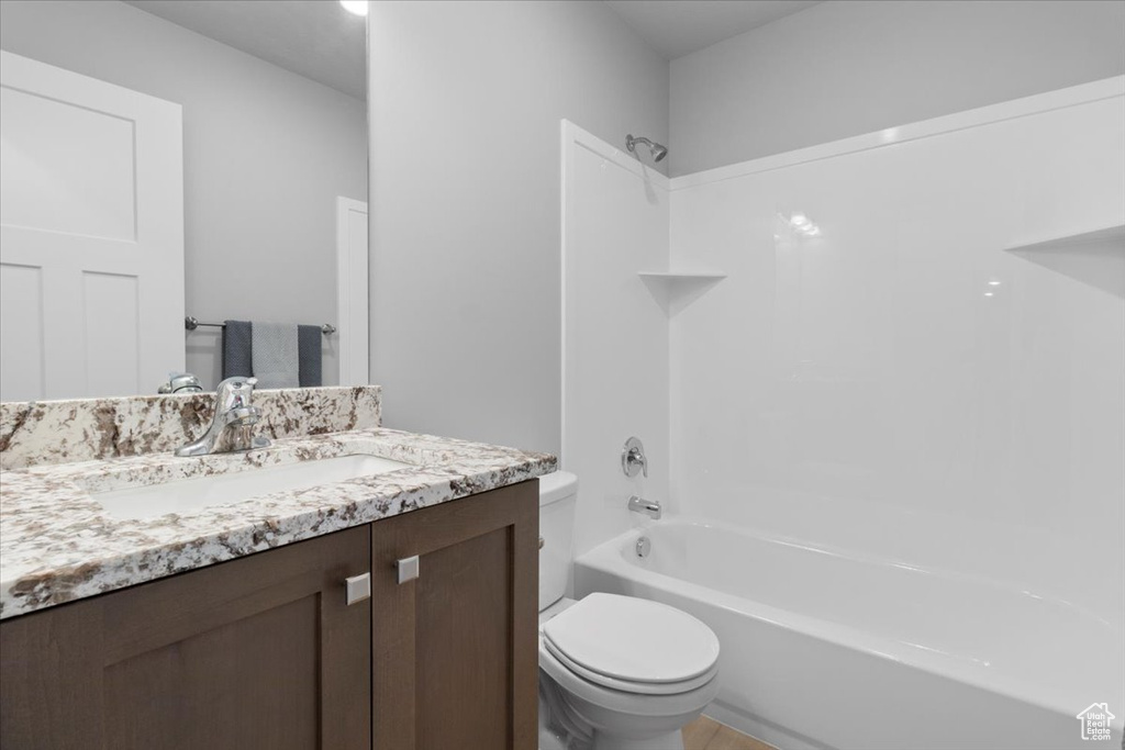 Bathroom featuring vanity and shower / washtub combination