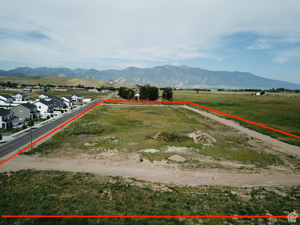 Overview of rural landscape featuring property parcel outlined and mountains