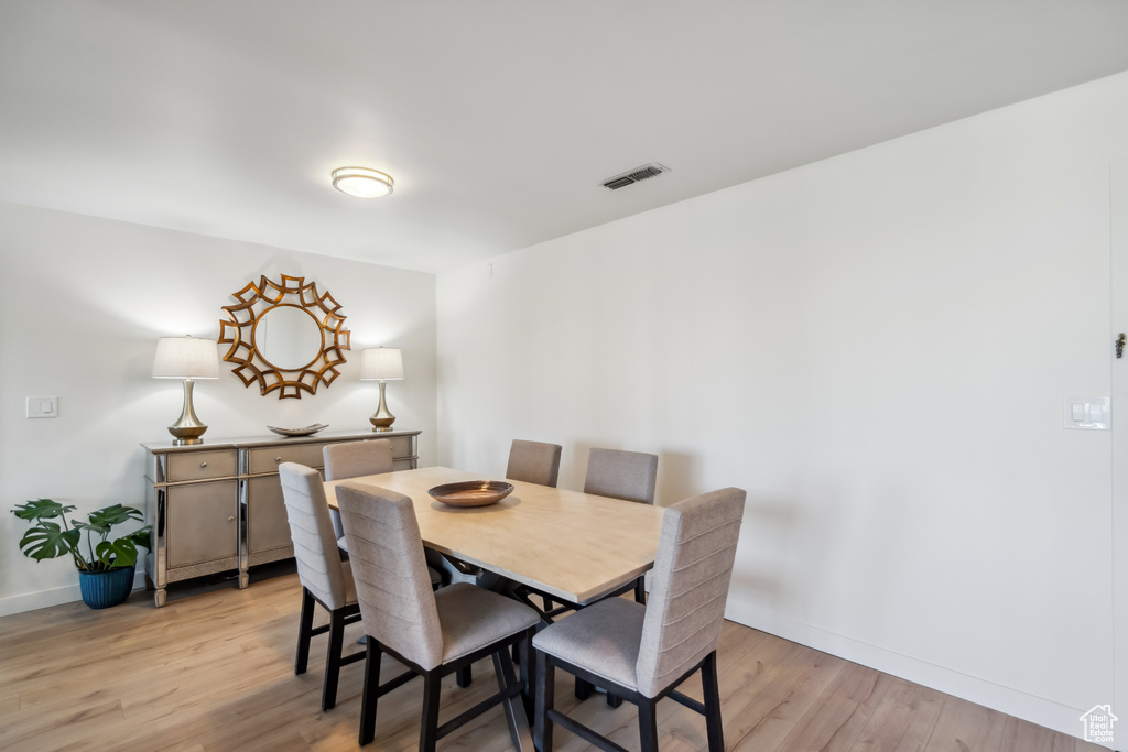 Dining area featuring light wood-style floors and baseboards