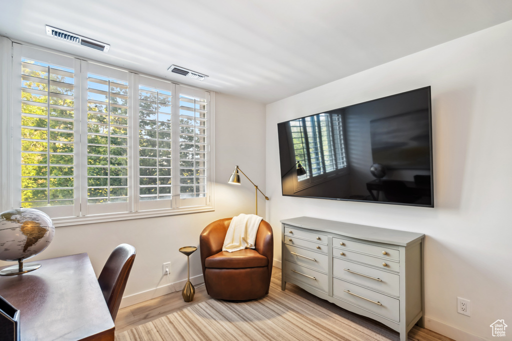 Office space featuring baseboards and wood finished floors