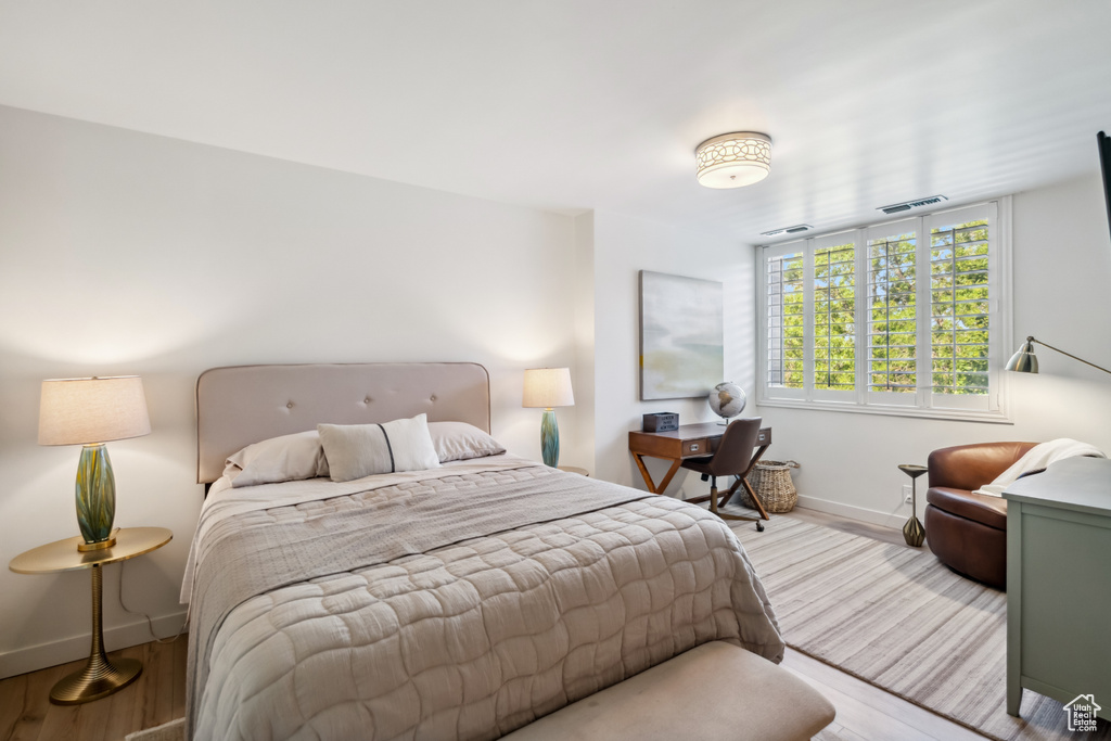 Bedroom featuring wood finished floors and baseboards