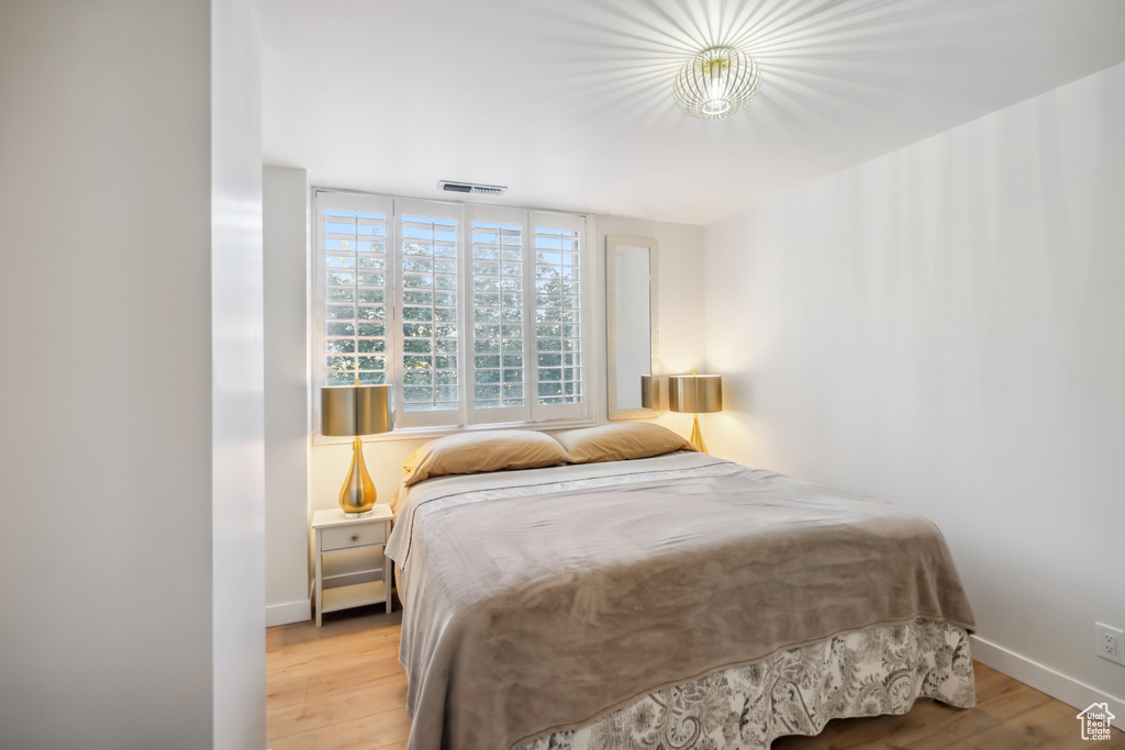 Bedroom with light wood-type flooring and baseboards
