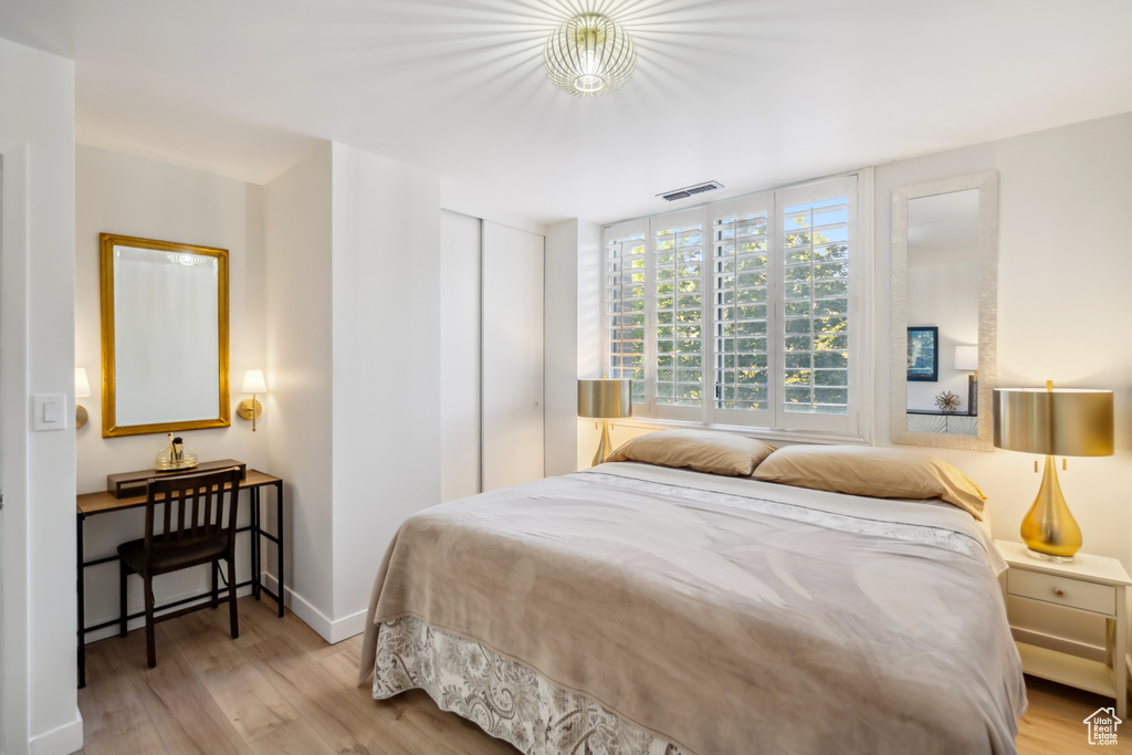 Bedroom featuring wood finished floors and a closet