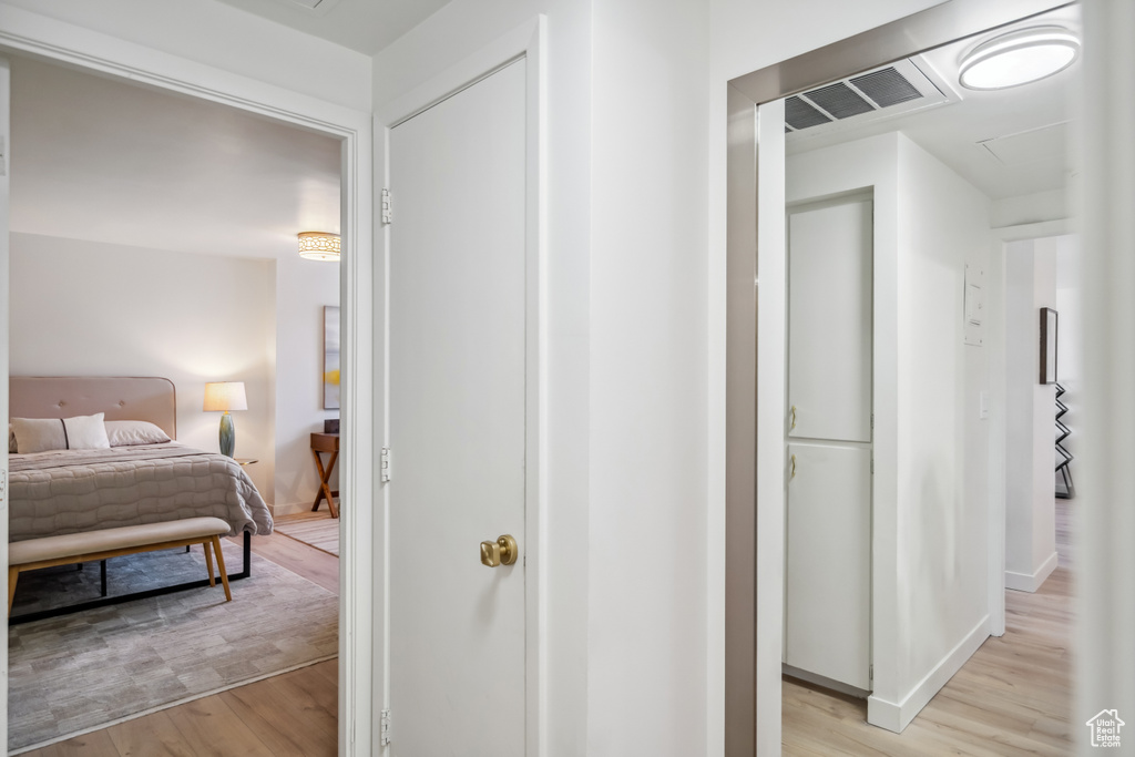 Hall featuring light wood finished floors and baseboards