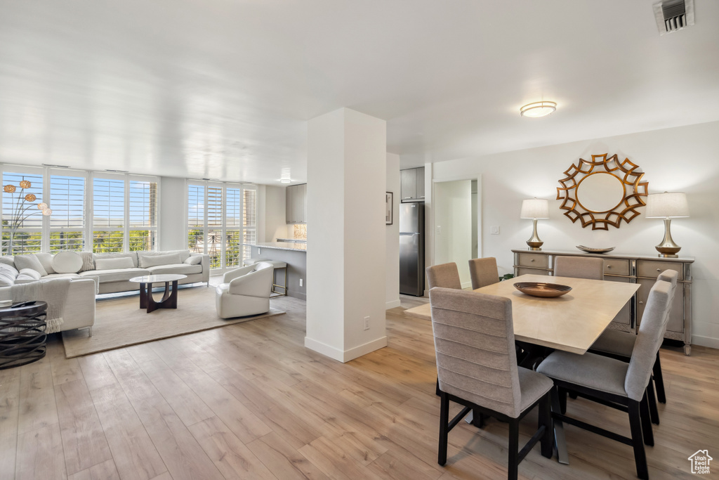 Dining area with light wood-style floors and baseboards