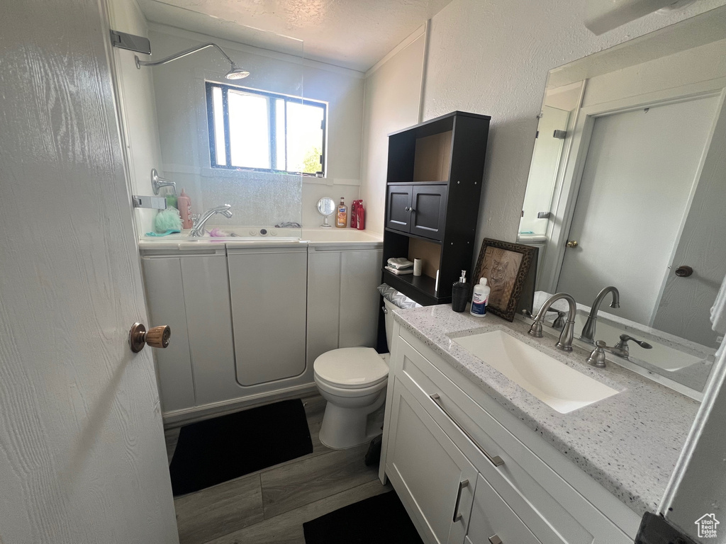Full bathroom featuring a tub and vanity