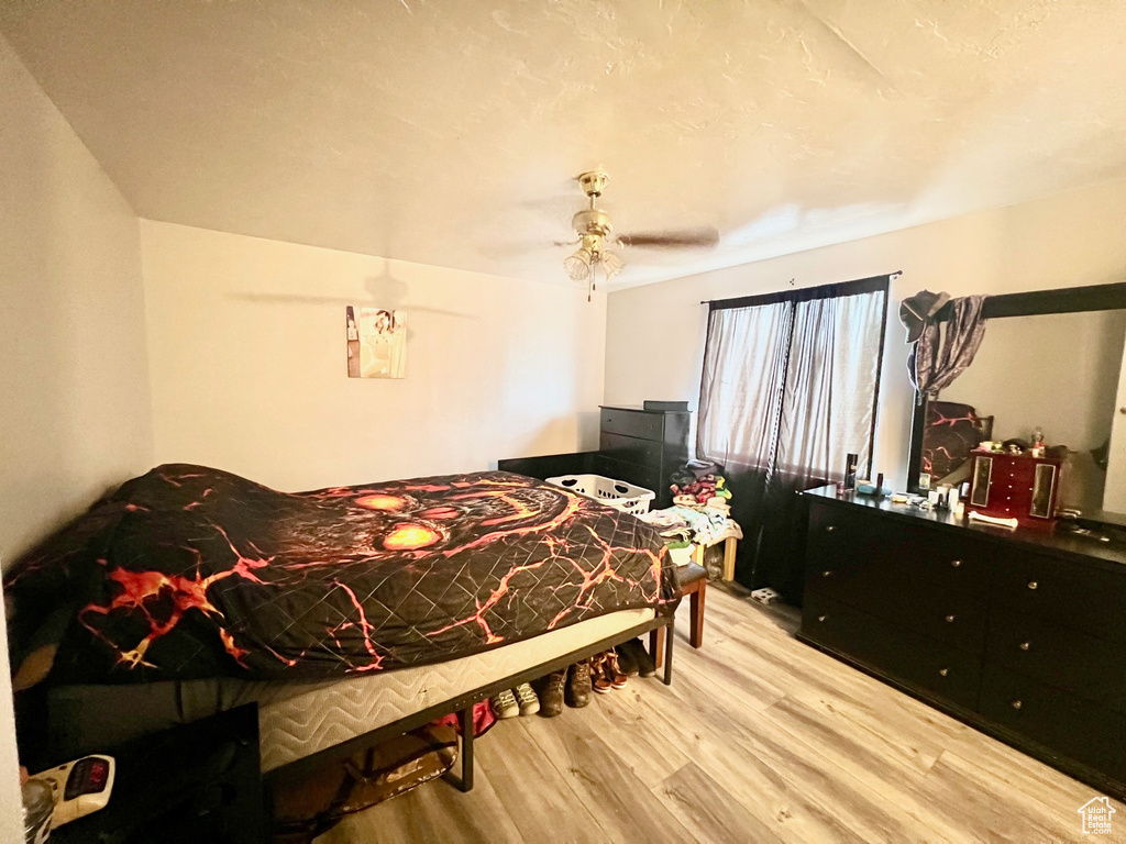 Bedroom featuring wood finished floors and ceiling fan