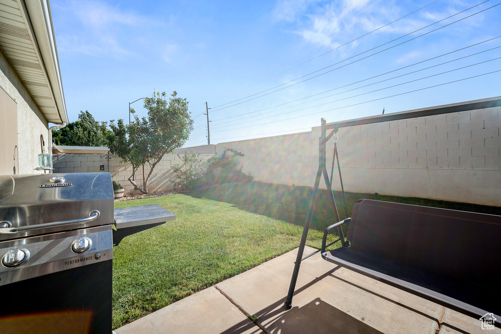 Fenced backyard with a patio