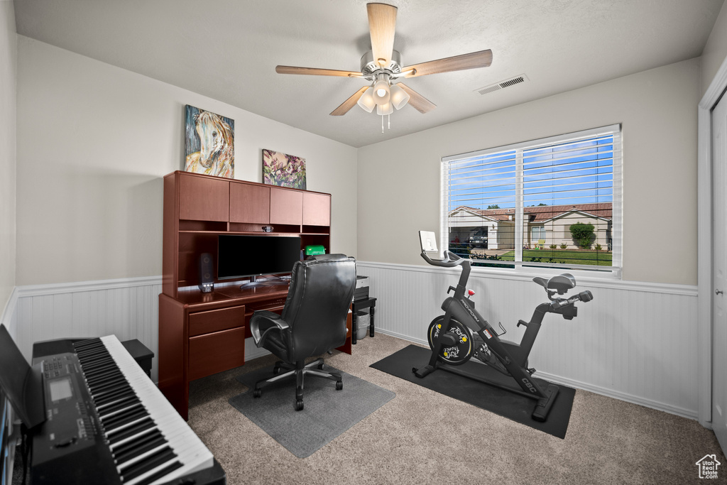 Office featuring wainscoting, carpet, and ceiling fan