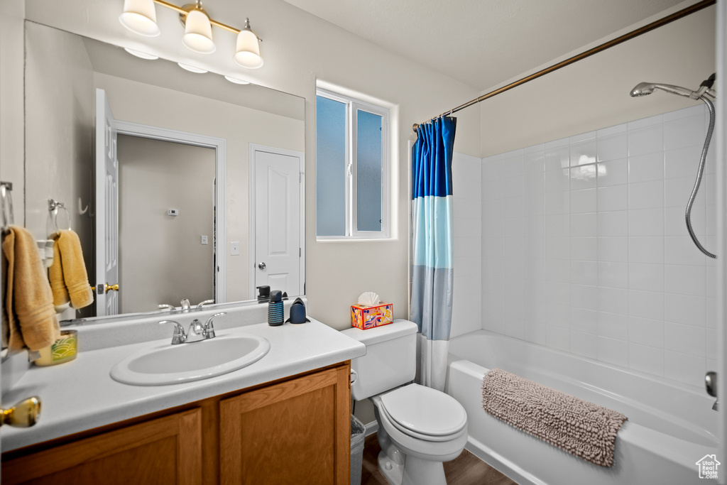 Full bathroom with shower / tub combo and vanity