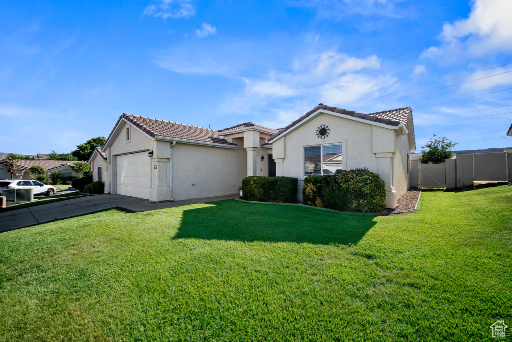 Mediterranean / spanish-style house featuring stucco siding, a garage, a tile roof, and driveway