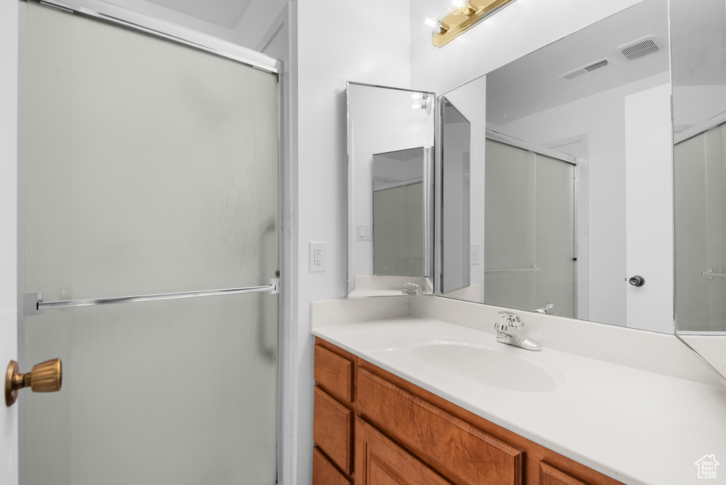 Full bath featuring a shower stall and vanity