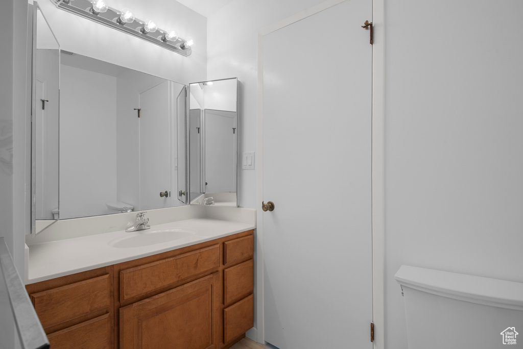Half bathroom featuring toilet and vanity