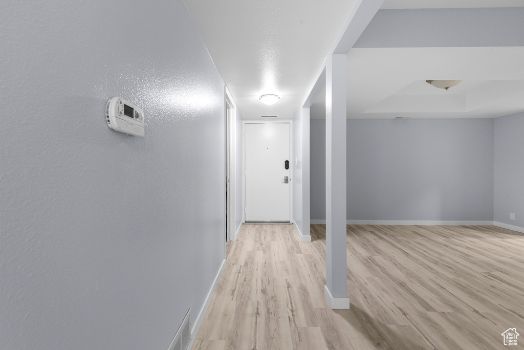 Hallway with light wood finished floors and baseboards