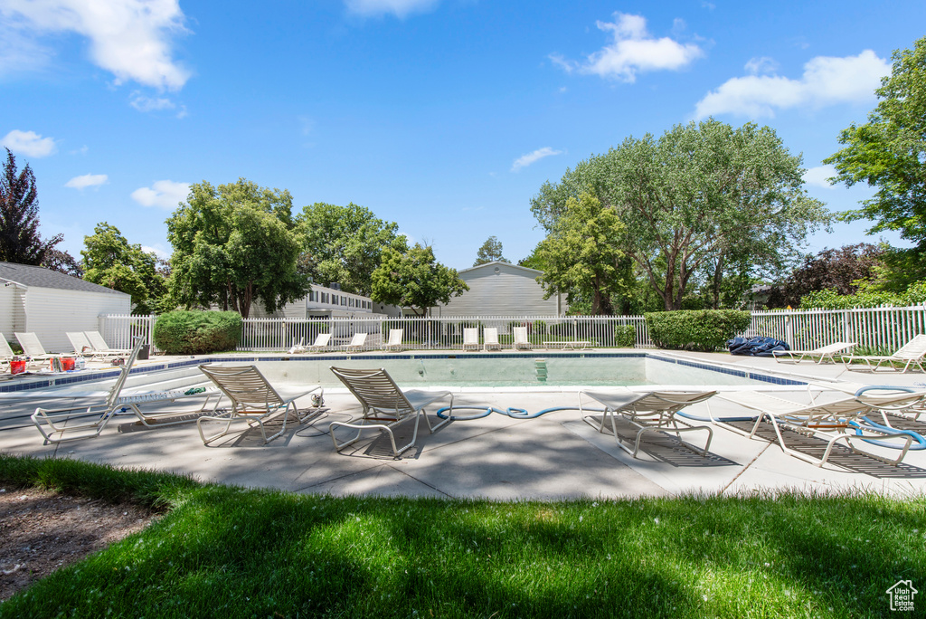 Community pool featuring a patio