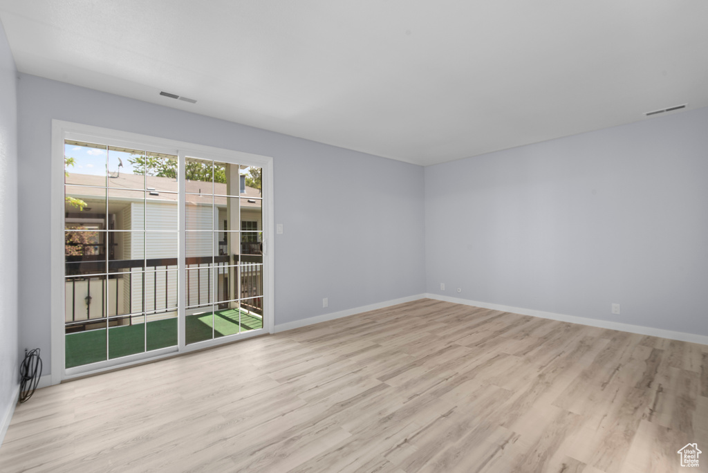 Empty room featuring wood finished floors and baseboards