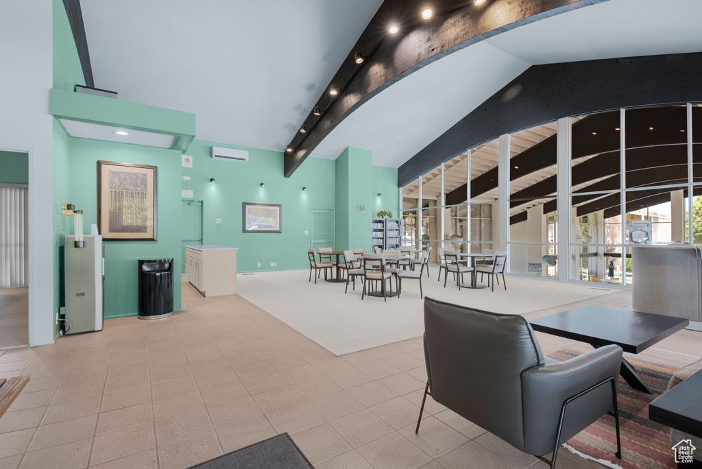 Dining room featuring tile patterned floors, beamed ceiling, carpet, and high vaulted ceiling
