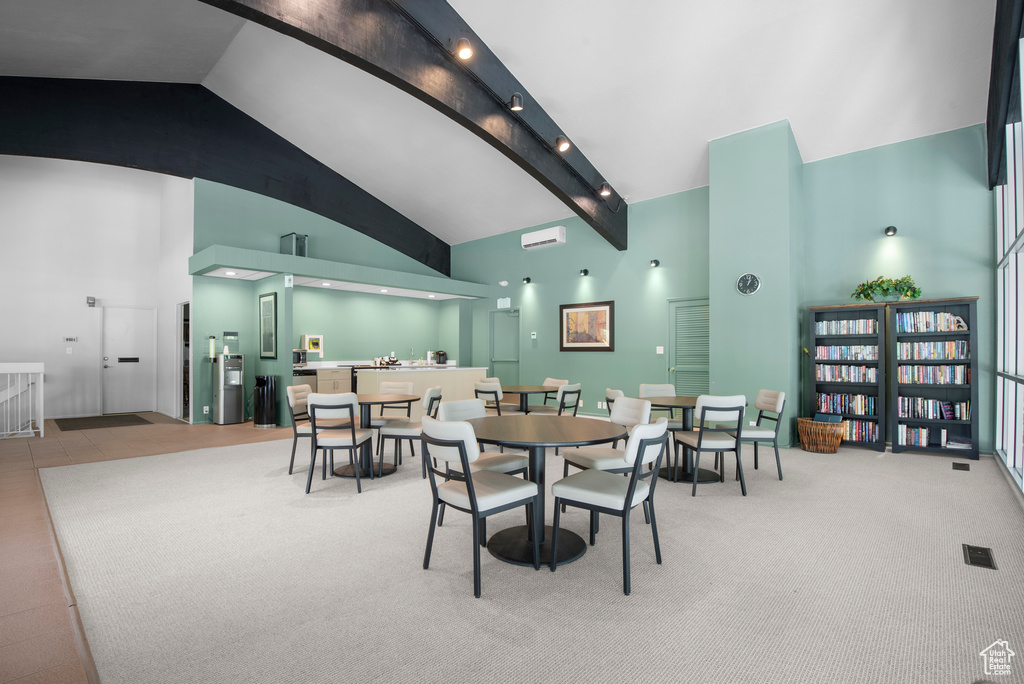 Carpeted dining room featuring high vaulted ceiling