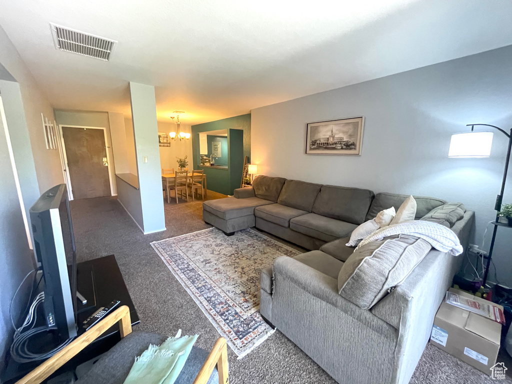 Living room featuring a chandelier and carpet