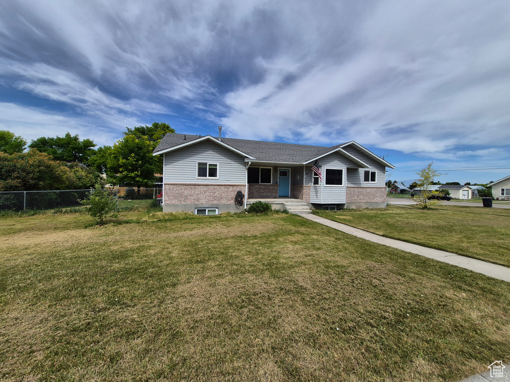 Ranch-style home featuring covered porch and brick siding