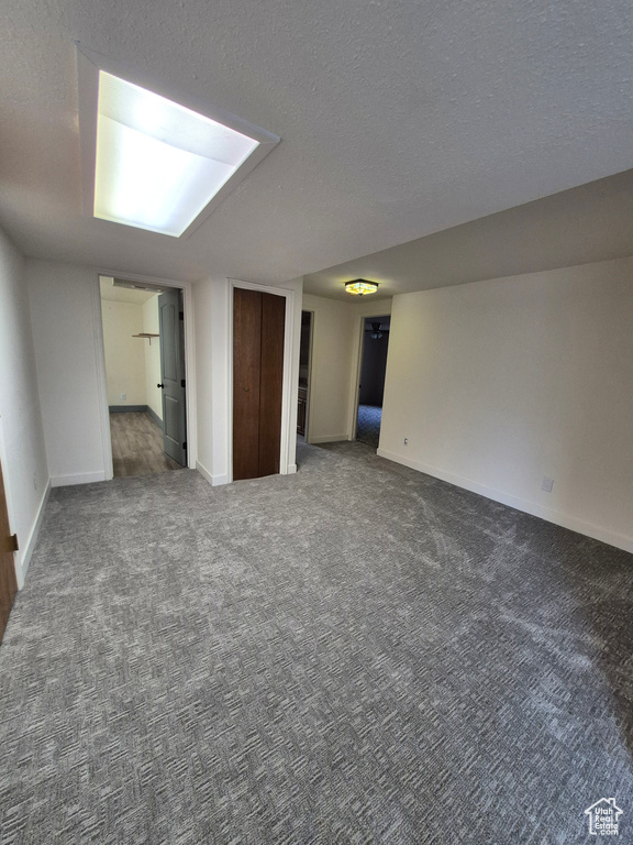 Spare room with carpet floors and a textured ceiling