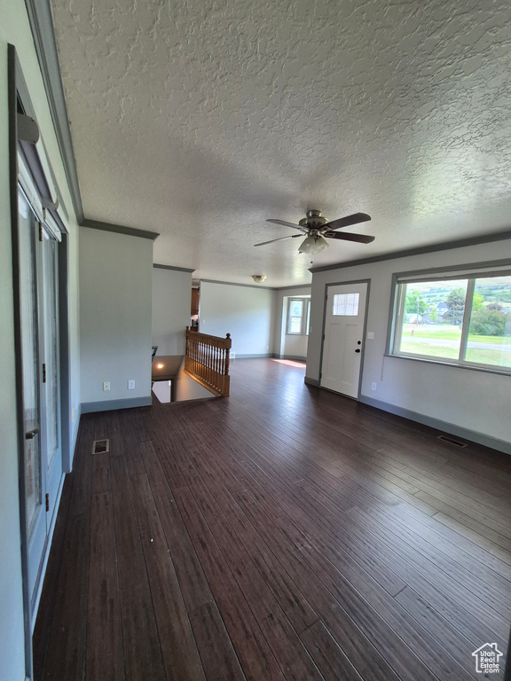 Foyer entrance featuring hardwood / wood-style flooring, ceiling fan, and a textured ceiling