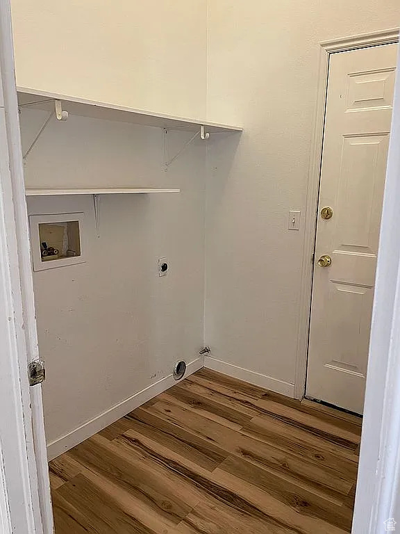 Laundry area featuring washer hookup, wood finished floors, and electric dryer hookup