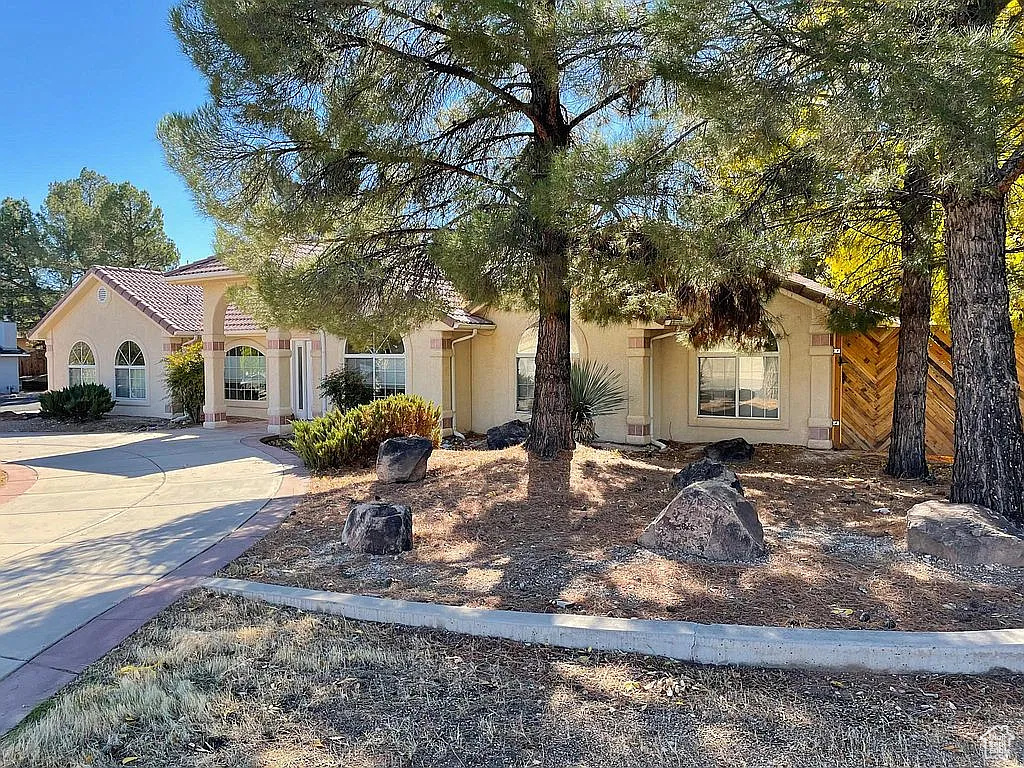 View of front of property featuring stucco siding and driveway