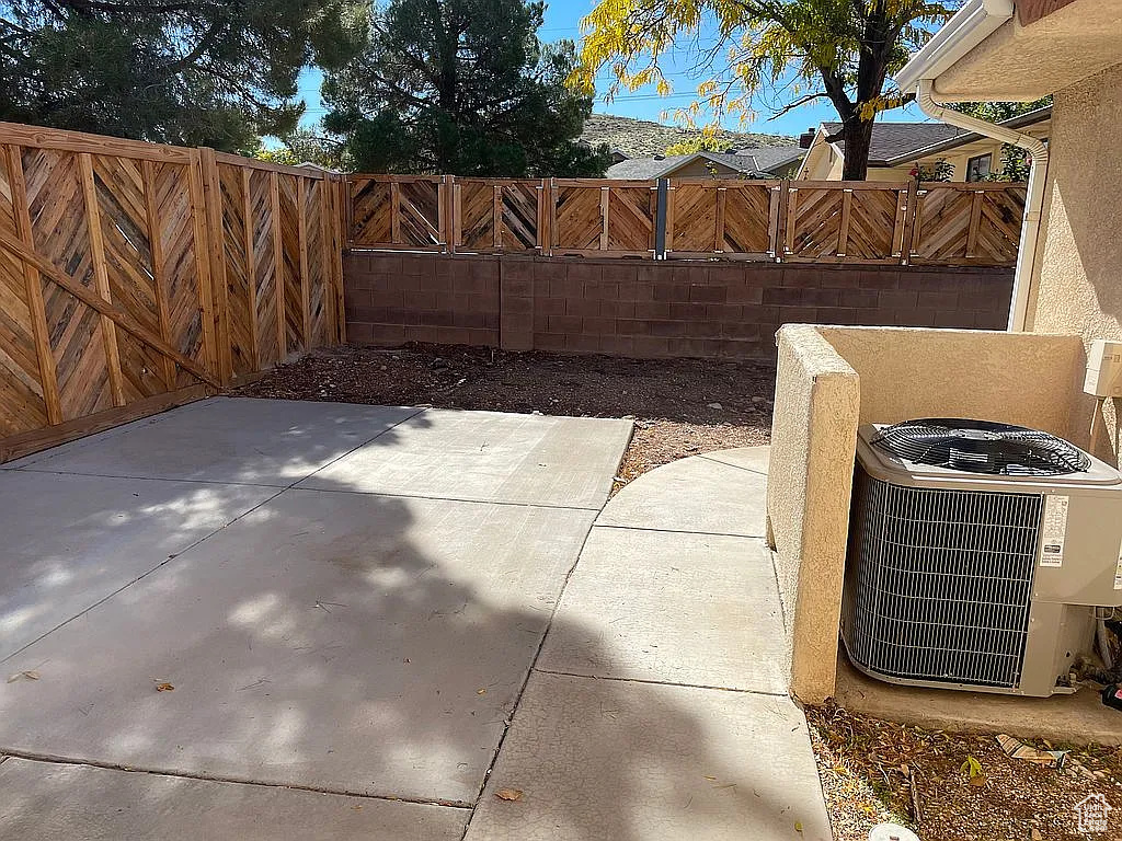 Fenced backyard with a patio