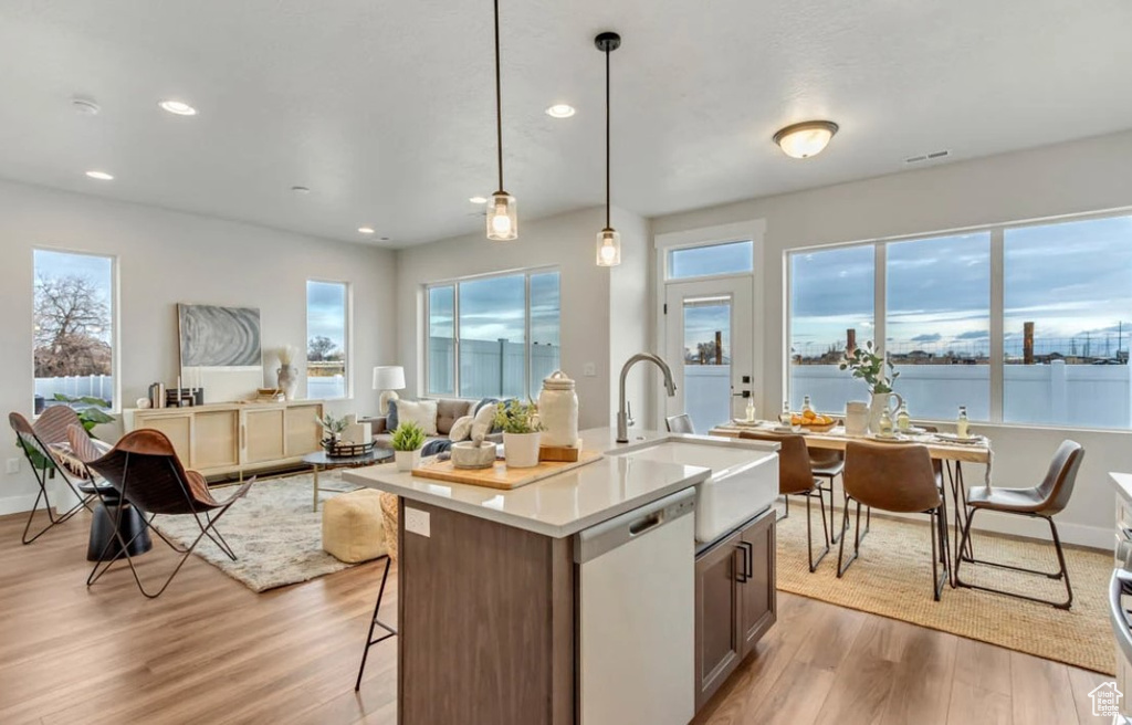 Kitchen with dishwashing machine, light wood-style floors, recessed lighting, plenty of natural light, and open floor plan